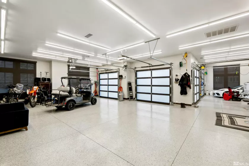 7+ car garage with designated HVAC system, epoxy floors, tandem parking, boat/RV storage, EV charging station.