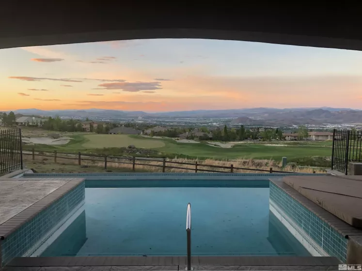 Infinity-edge pool overlooking 6th fairway and Reno city lights- unrivaled ArrowCreek view.