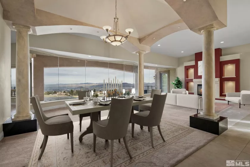 Dining/Living room with columns and picture-window wall showcasing ArrowCreek fairway & mountains.