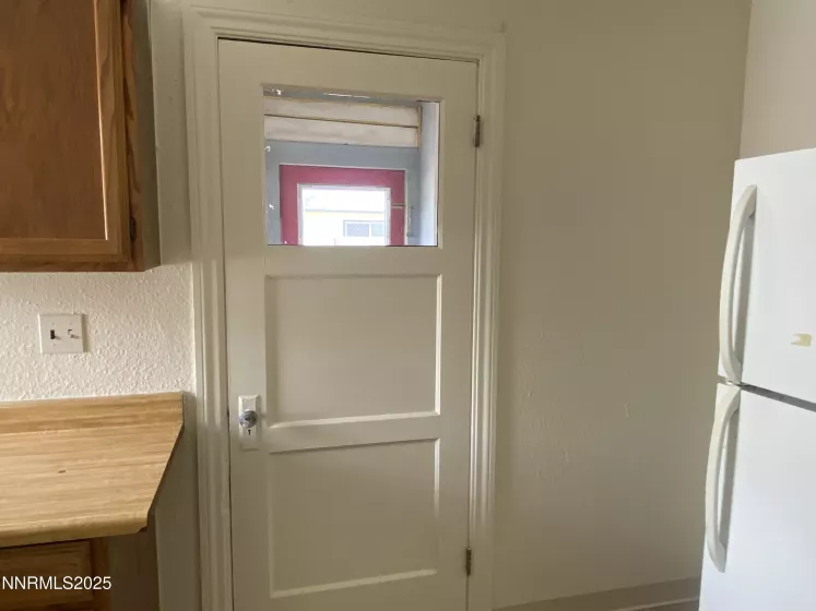 Kitchen Refrigerator and entry to back enclosed porch