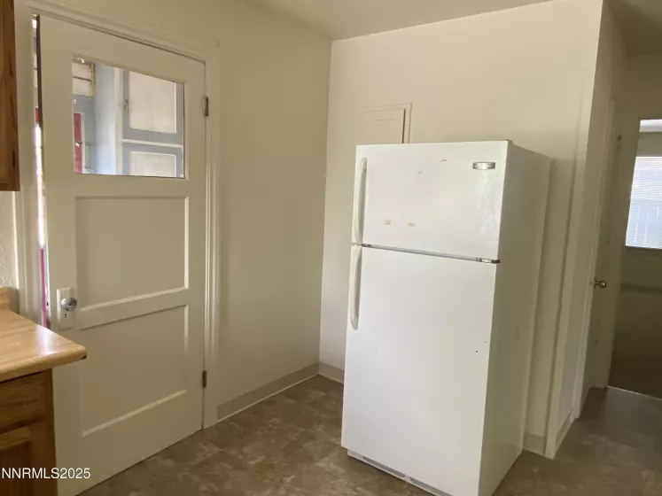 Kitchen Refrigerator and entry to back enclosed porch