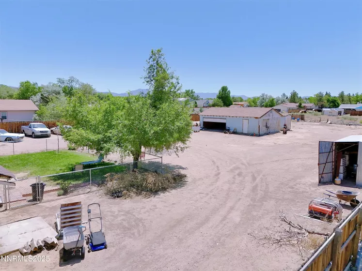 Overhead view of backyard and separate garage and shed