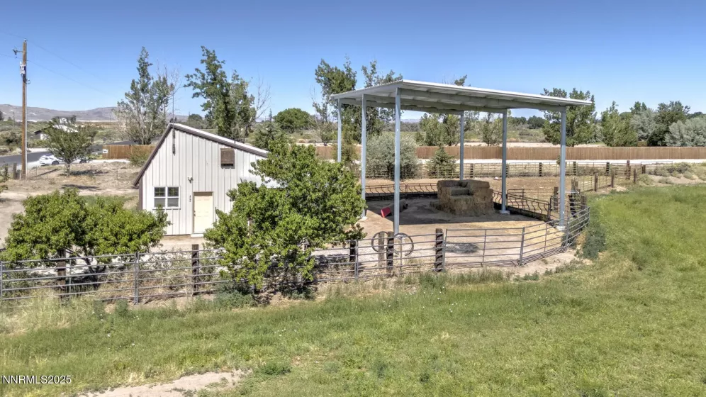 West view of field, hay storage, shop and the beautiful producing fruit trees
