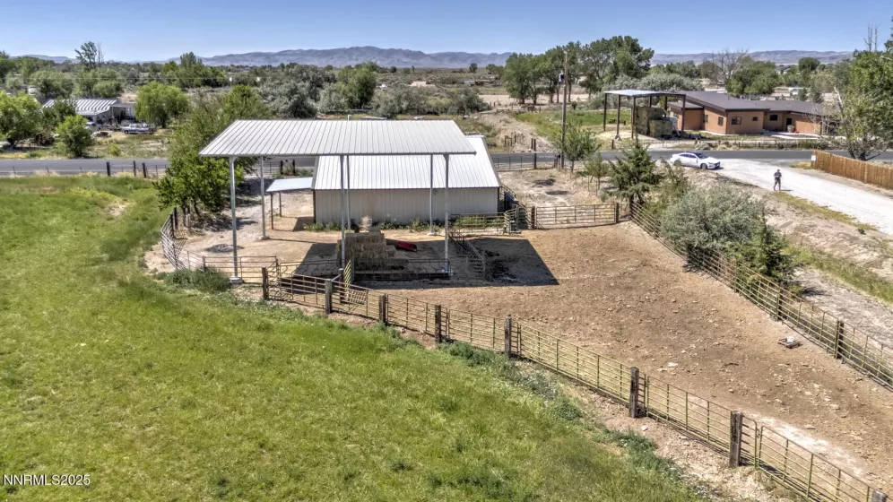 Over view of fenced corral hay storage and shop, looking east