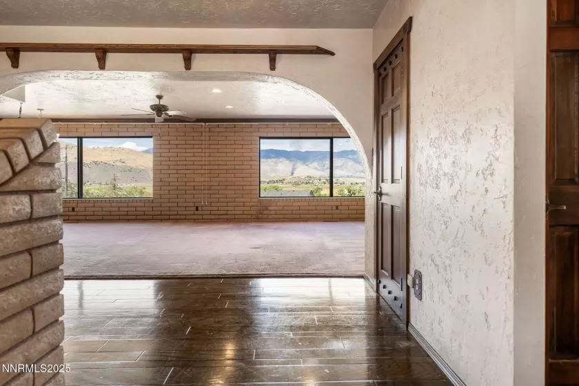 Foyer to the Great Room with Panoramic views with custom retractable metal blinds for west side windows.
