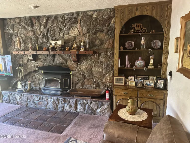 Rock wall with wood burning fireplace