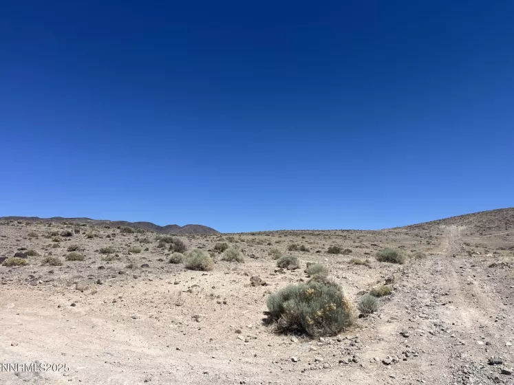 corner of Apache Dr. & Wildflower Rd. (looking up the hill at the parcel)