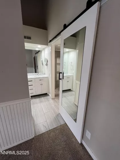 Primary Bathroom en-suite entry with mirrored barn door