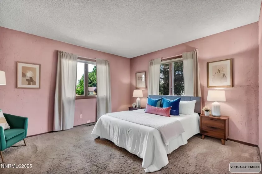 Guest bedroom 1 features spacious layout, abundant natural light, and ample closet space.
