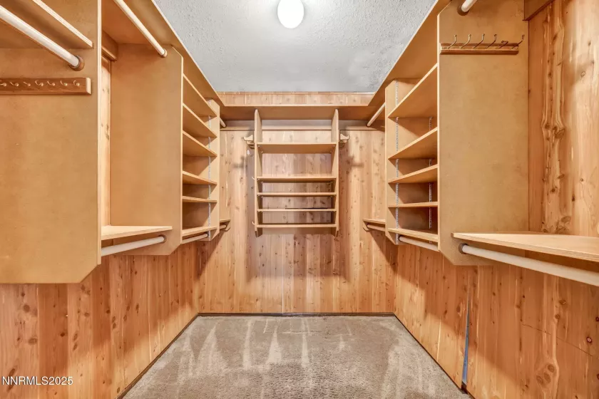 Spacious walk-in cedar closet featuring built-in shelves for organized and elegant storage.