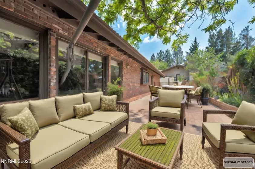 Expansive open patio in a private setting, accessible from both the great room and primary bedroom.