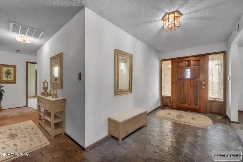 Step into a spacious foyer that sets the tone with vintage charm and a warm, welcoming feel.