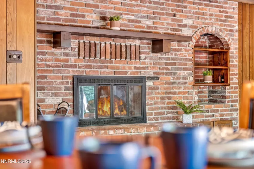 Cozy wood-burning brick fireplace that adds warmth and timeless character to the living space.