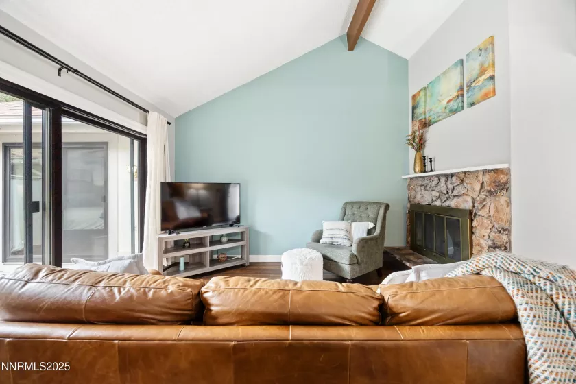 Living room with cathedral ceilings and slider to private patio courtyard