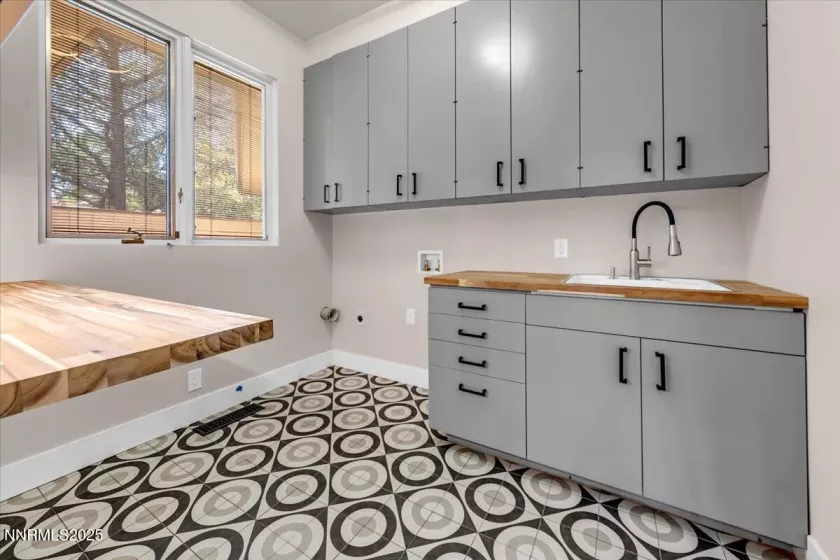 laundry room with cabinets and shelving.