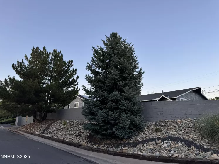 Elevated driveway, retaining wall, level front lot with mountain Views