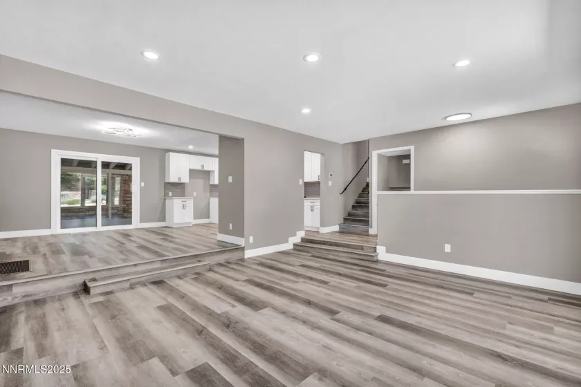 Main floor living room, dining area and stairs leading to bedrooms