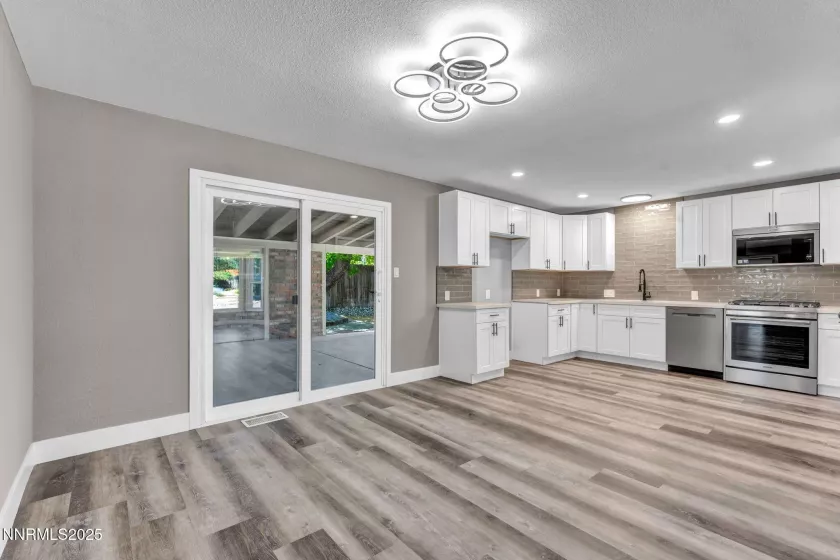 Dining area leading to kitchen and backyard