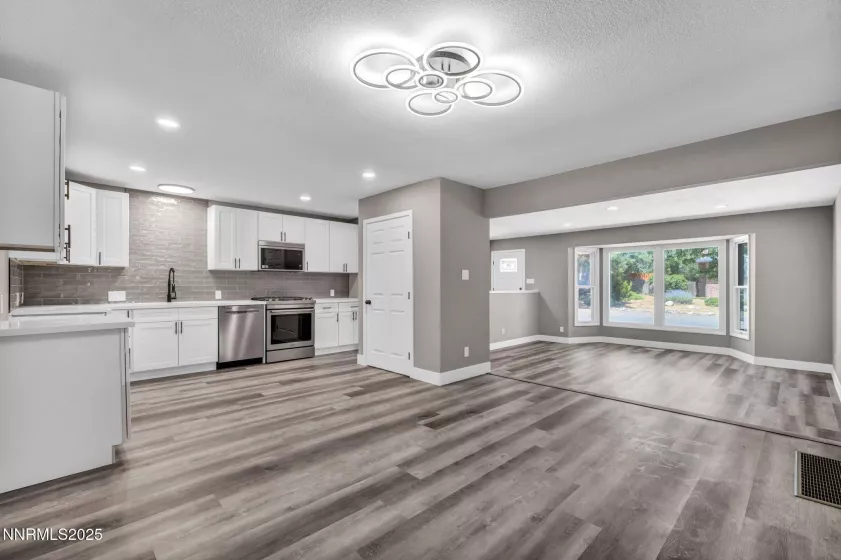 Looking in from sliding glass door to kitchen, dining and living room