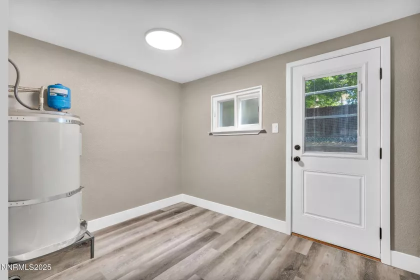 Laundry room with new hot water heater door to back yard