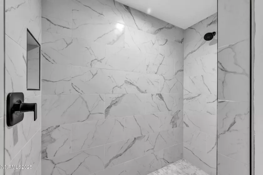 Primary ensuite walk-in shower stall with two shower heads