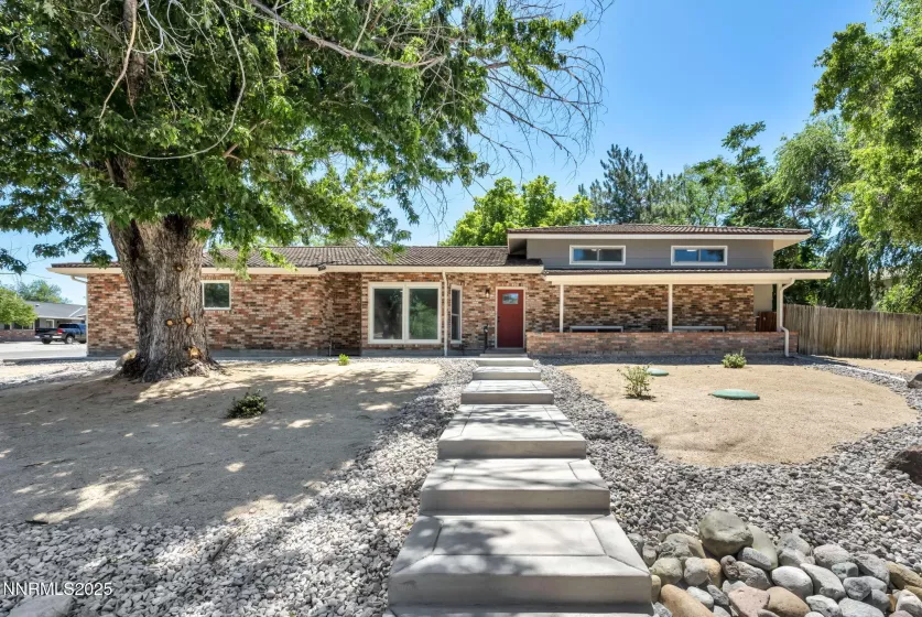 Front of home with new landscaping and concrete walk way