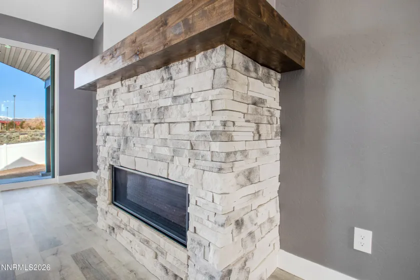 Previously built home showing Electric Fireplace with masonry detail and stained wrap around mantel