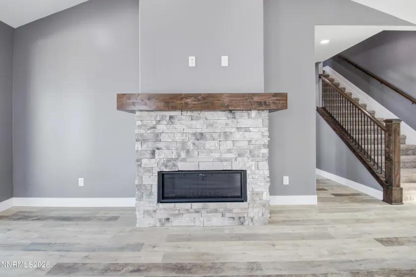 Previously built home showing Electric Fireplace with masonry detail and stained wrap around mantel