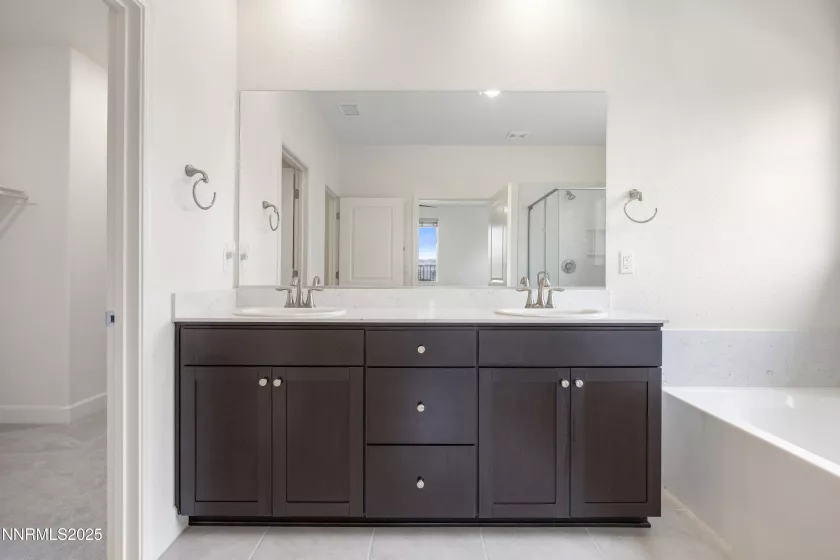 Primary bathroom featuring dual sinks