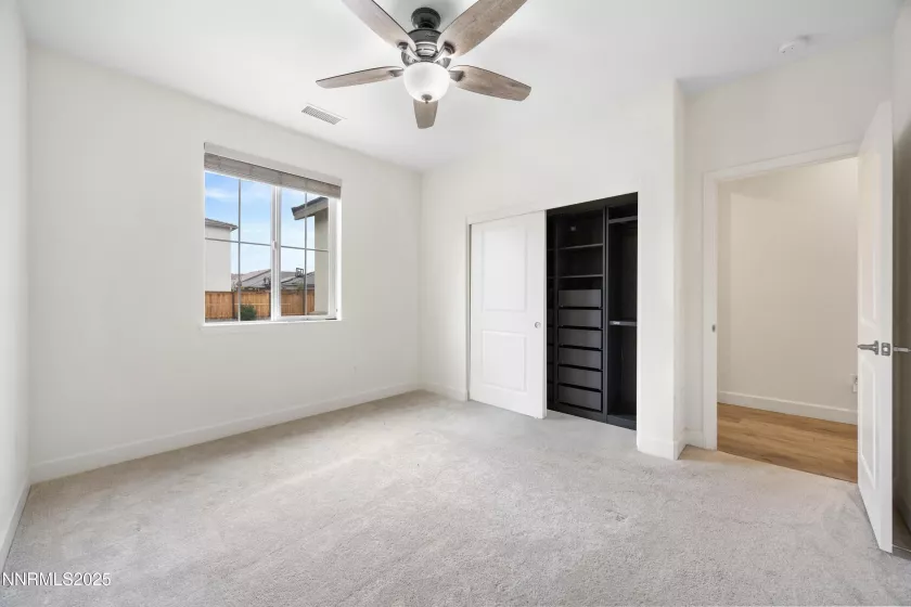 Bedroom featuring custom built-in closets