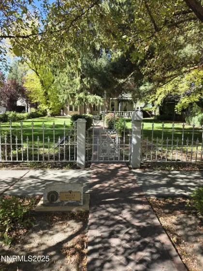 Man gate at front sidewalk w/ historical plaque