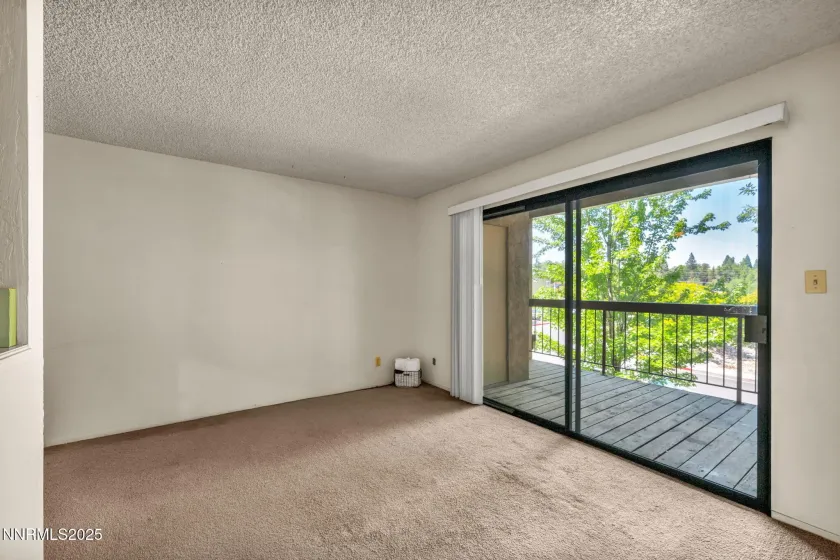 Living area and sliding glass door to deck.