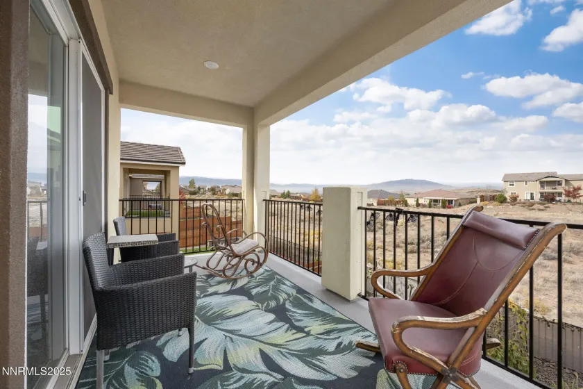 Balcony off primary bedroom with city views Balcony off primary bedroom with city views