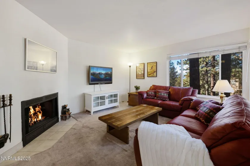 Living room with open wood burning fireplace.