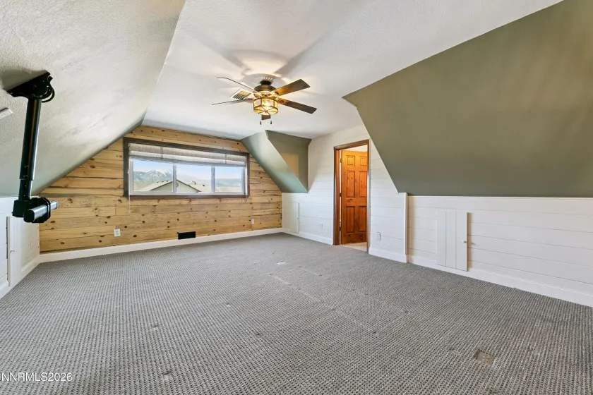 Loft at top of stairs with half bath on right