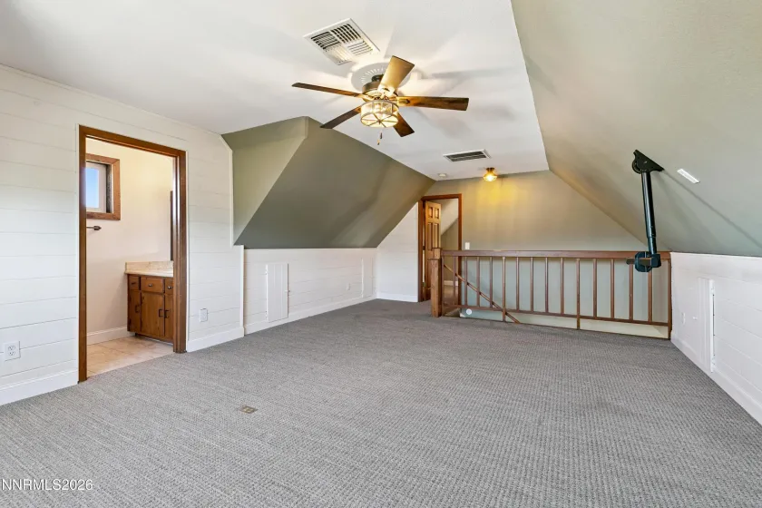 Loft at top of stairs with half bath on left