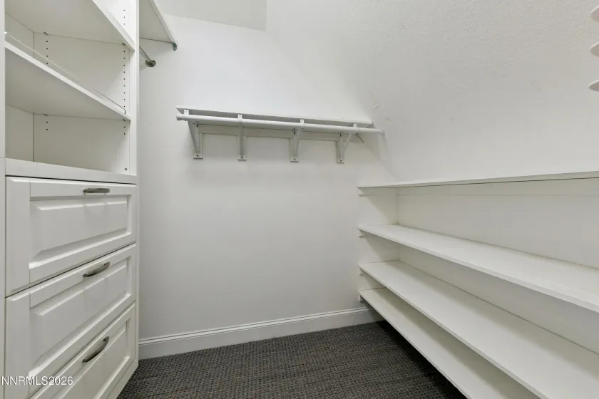 Primary bedroom walk in closet one