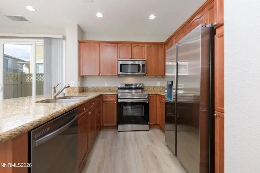 Kitchen with new appliances including refrigerator
