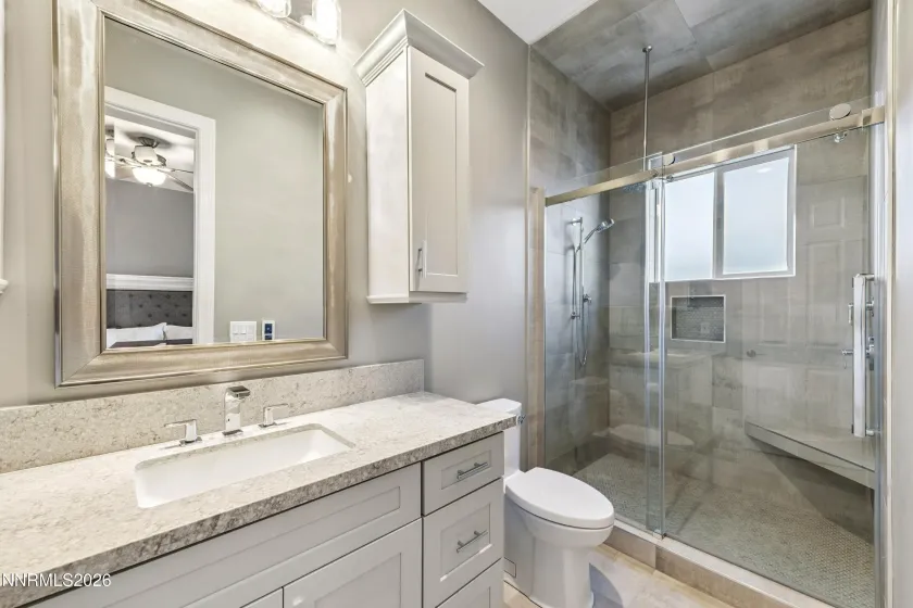 Ensuite bathroom for bedroom three includes a walk-in shower with grab bars.