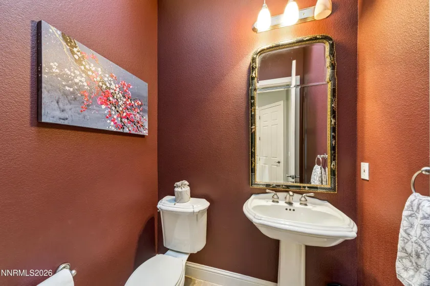 Powder room between garage entry and kitchen.