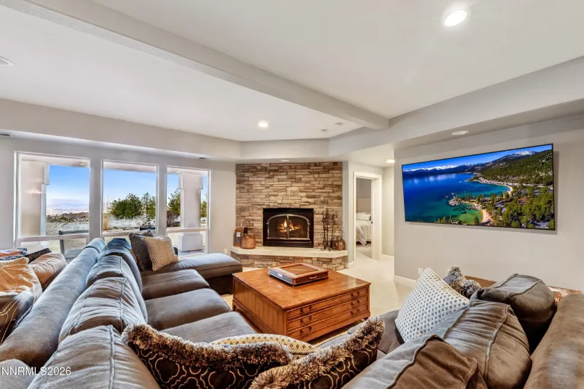 Recreation lounge with fireplace in daylight basement.
