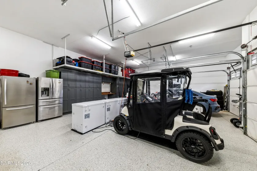 Attached three car garage with epoxy floors and built in storage.