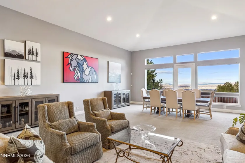Formal living and dining room combination with expansive view windows.