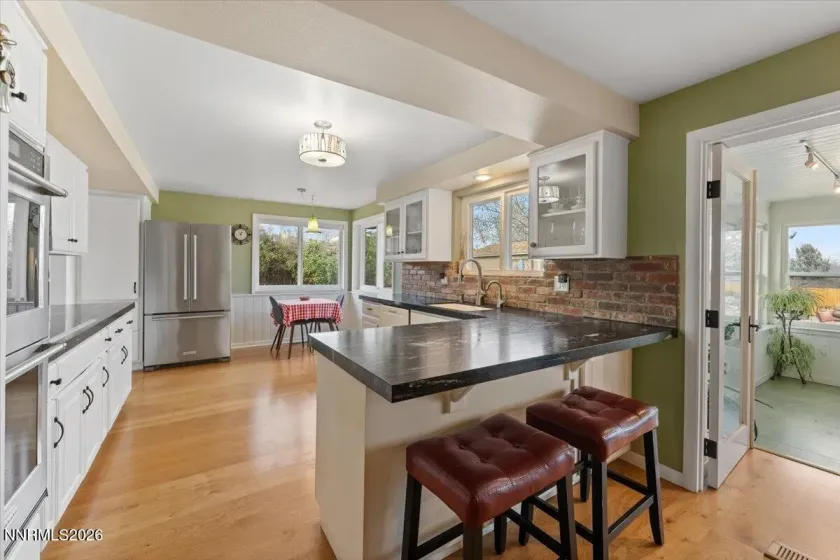 Kitchen with sunroom to right.