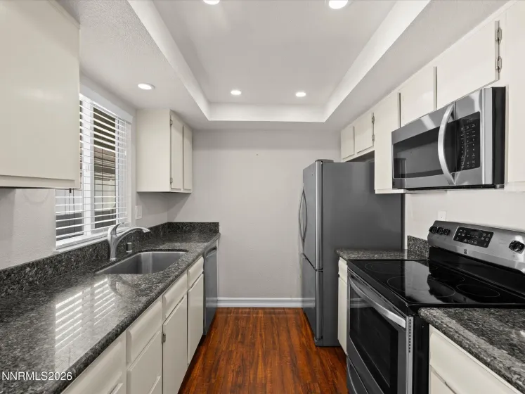 Updated kitchen with granite slab and stainless appliances