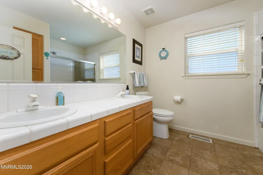 Guest bath with tub shower combo and floor to ceiling cabinets