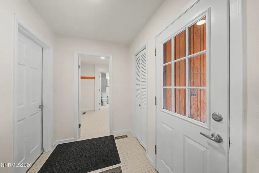 Entry to Mud Room With access to basement and attached garage to the left and backyard patio to the right.