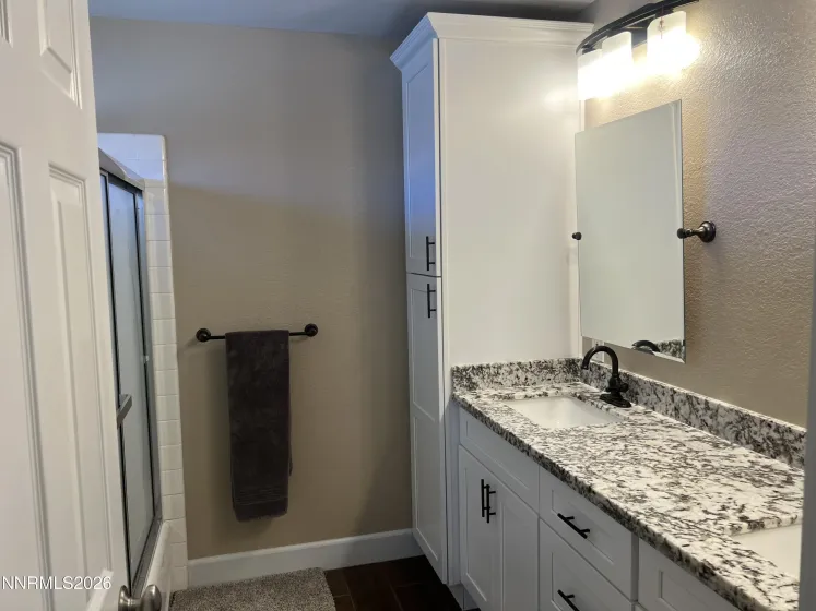 Primary bathroom double with sinks and tub shower combo.