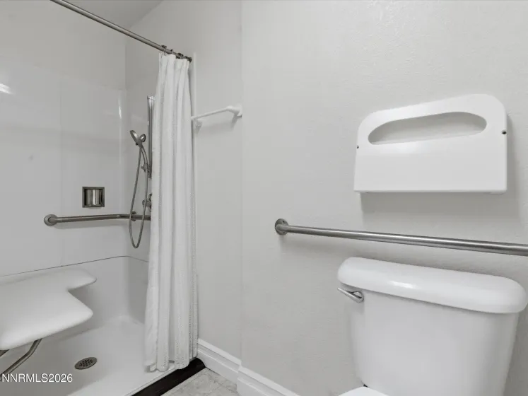 ADA-accessible restroom with grab bars and accessible layout