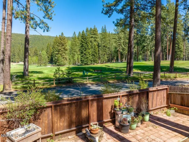 Fenced backyard overlooking golf course
